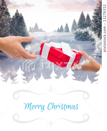 Composite image of couple passing a wrapped gift 13276352