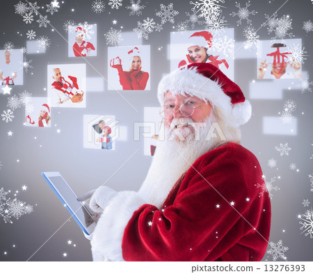 Composite image of santa uses a tablet pc and smiles into the ca Composite image of santa uses a tablet pc and smiles into the ca 13276393