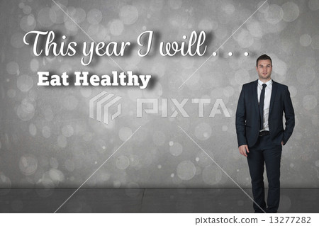 Composite image of businessman standing with hand in pocket 13277282