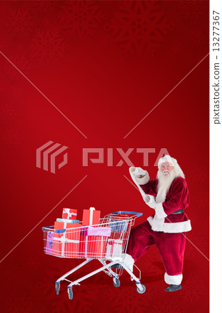 Composite image of santa pushes a shopping cart while reading Composite image of santa pushes a shopping cart while reading 13277367