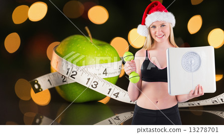 Composite image of festive fit blonde smiling at camera 13278701
