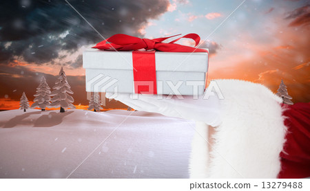 Composite image of santa claus showing gift with red ribbon 13279488