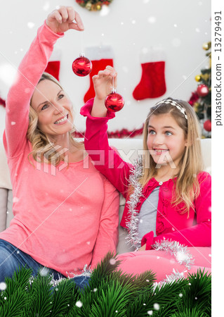 Composite image of festive mother and daughter smiling at camera Composite image of festive mother and daughter smiling at camera 13279491