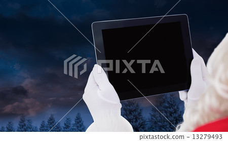 Composite image of santa claus using tablet pc 13279493