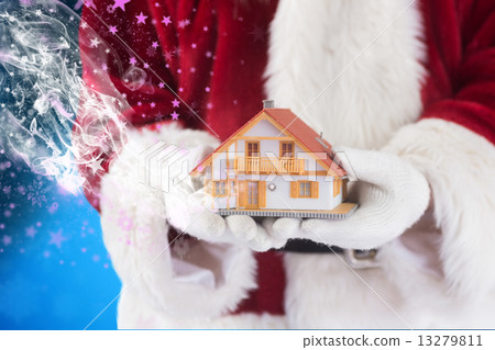 Composite image of santa holds a tiny house in his hands 13279811