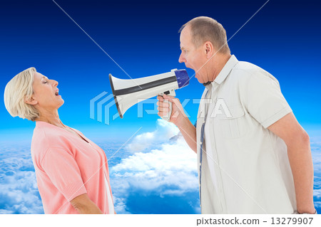 Composite image of man shouting at his partner through megaphone 13279907