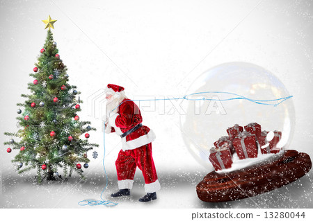 Composite image of santa pulling snow globe of presents 13280044