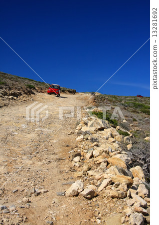 The car on a dirt road on a mountain slope. Greece. Rhodes.. 13281692