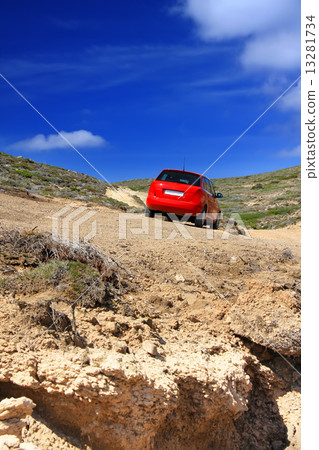 The car on a dirt road on a mountain slope. Greece. Rhodes.. The car on a dirt road on a mountain slope. Greece. Rhodes.. 13281734
