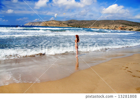 Greece. Rhodes. The young beautiful woman on seacoast... 13281808