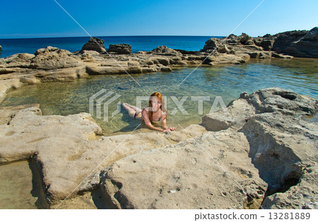 Greece. Rhodes. The young beautiful woman on seacoast... 13281889