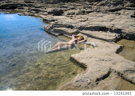 Greece. Rhodes. The young beautiful woman on seacoast... 13281891
