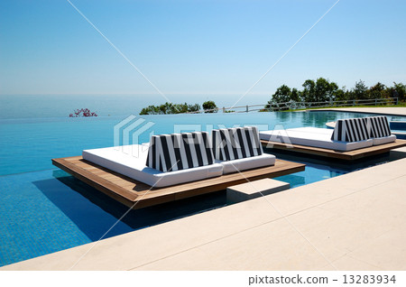 Infinity swimming pool by beach at the modern luxury hotel, Pier Infinity swimming pool by beach at the modern luxury hotel, Pier 13283934