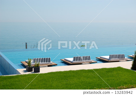 Infinity swimming pool by beach at the modern luxury hotel, Pier Infinity swimming pool by beach at the modern luxury hotel, Pier 13283942