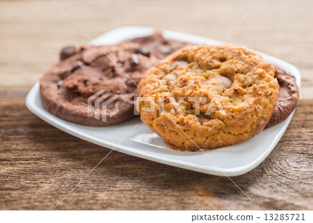 Pile of chocolate chip cookies on a white plate 13285721