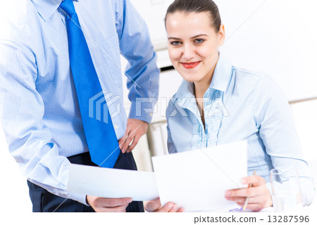 colleagues discuss the reports 13287596