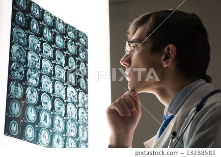 male doctor looking at the x-ray image male doctor looking at the x-ray image 13288581