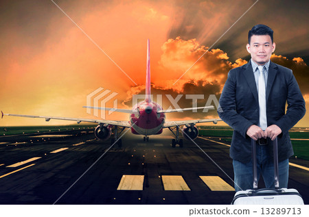 young man and luggage standing against passenger jet plane prepa young man and luggage standing against passenger jet plane prepa 13289713