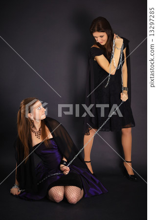 Two young girls playing master and slave 13297285