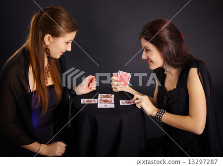Two girls friends engaged in fortune-telling cards 13297287