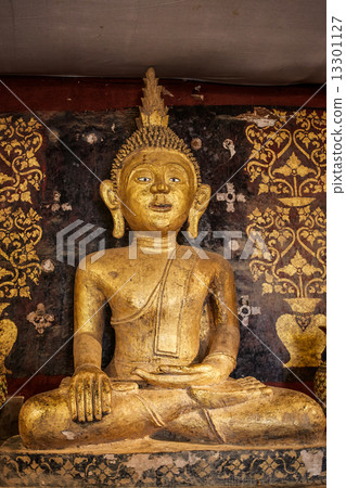 Old antique statue of Buddha in a temple room. Thailand 13301127