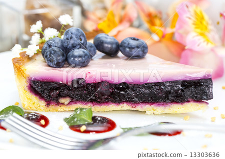 piece of blueberry pie on a table in a restaurant 13303636
