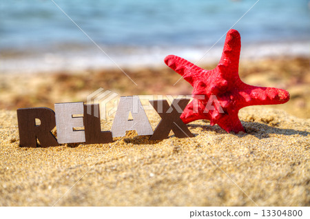Wooden word 'Relax' with red starfish 13304800