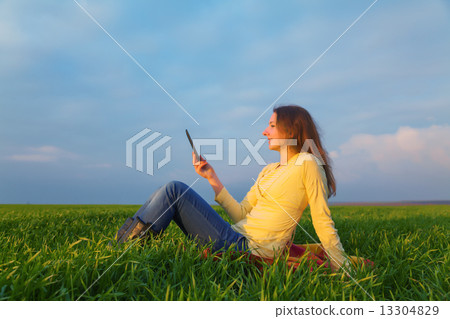 Teen girl reading electronic book 13304829