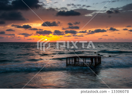 Tropical Beach with Empty Cage in the Sea at Sunset 13306078