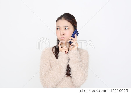 A young woman talking on a mobile phone 13310605