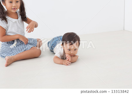 infant, slithering across the floor, older sister and younger brother 13313842