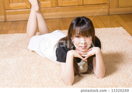 A lady lying on a rug mat 13320289