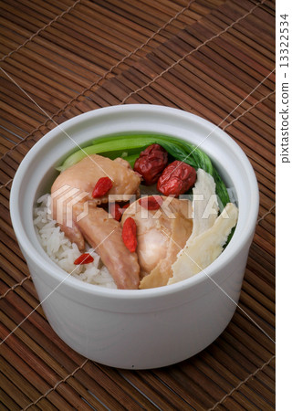 Chicken with rice and vegetables in background Chicken with rice and vegetables in background 13322534