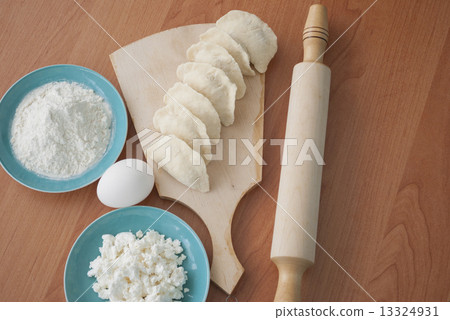 Uncooked dumplings on the cutting board 13324931