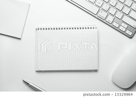 Spiral Notes Surrounded by Office Stuffs on Table Spiral Notes Surrounded by Office Stuffs on Table 13329964