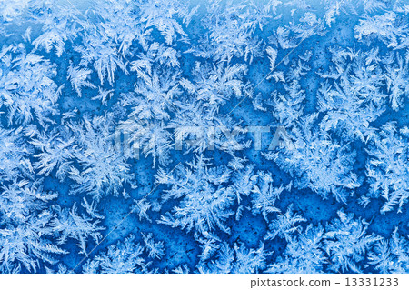 snowflakes and frost on window in winter close up 13331233