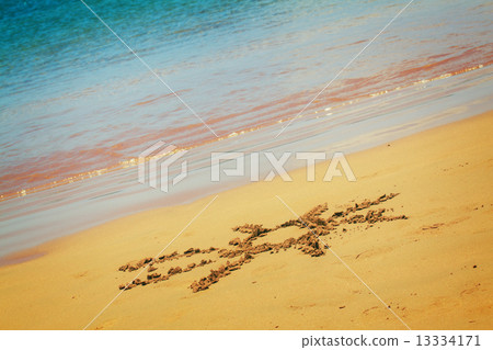 sun drawn on sandy beach 13334171