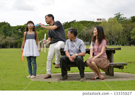 3 generations family day playing at the park 13335827