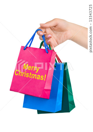 Hand with shopping bags Merry Christmas 13343725