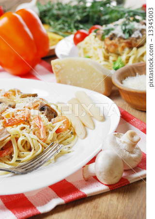 Pasta with shrimps and mashrooms on the wooden table Pasta with shrimps and mashrooms on the wooden table 13345003