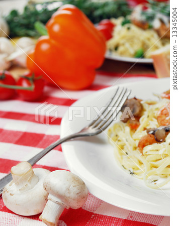 Pasta with shrimps and mashrooms on the wooden table Pasta with shrimps and mashrooms on the wooden table 13345004