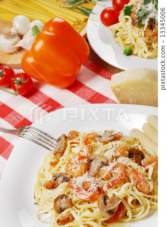 Pasta with shrimps and mashrooms on the wooden table Pasta with shrimps and mashrooms on the wooden table 13345006