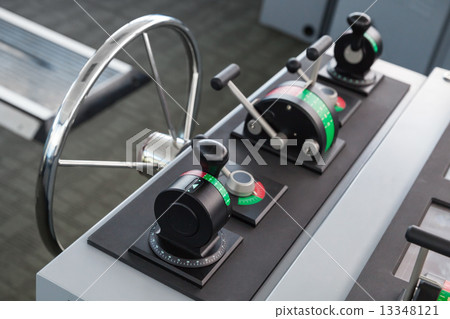 Modern ship control panel with steering wheel 13348121