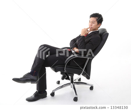 Man sitting and thinking on office chair 13348130