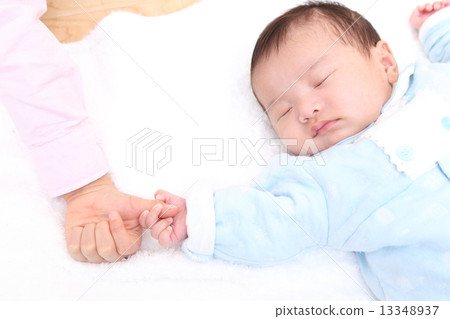 Baby and child's hand 13348937