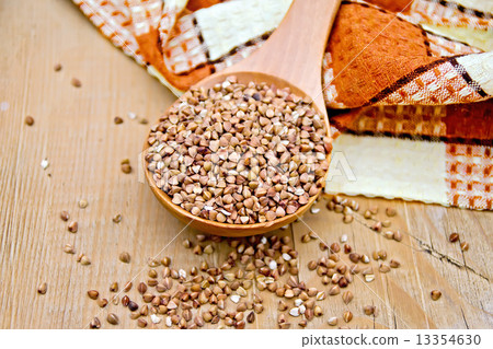 Buckwheat in spoon and napkin on board Buckwheat in spoon and napkin on board 13354630