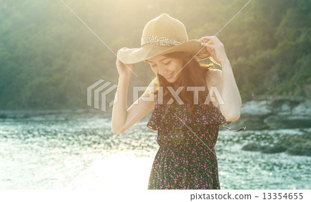 portrait of young beautiful woman wearing long dress and wide st 13354655