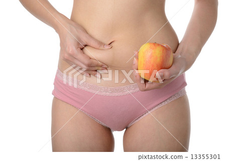 Beautiful slim woman holding apple while checking her fat,Diet c 13355301