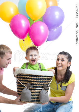 family playing with son in flight on a makeshift balloon  13356038