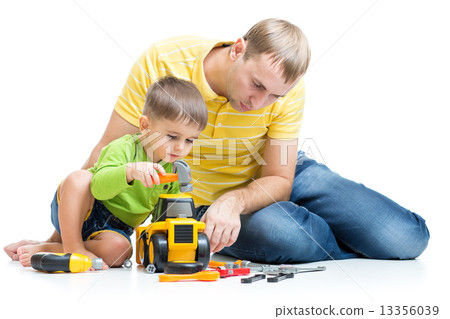 child and his dad repair toy tractor 13356039